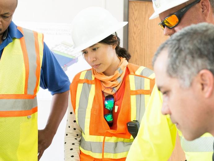 Female Keller project manager talking with colleagues